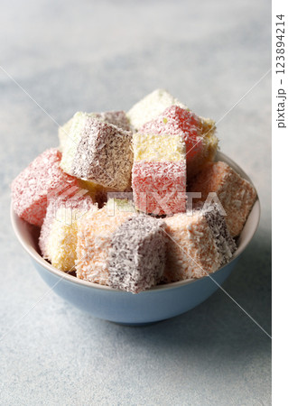 Colorful coconut treats arranged in a bowl, perfect for festive gatherings and celebrations Colorful coconut treats arranged in a bowl, perfect for festive gatherings and celebrations 123894214