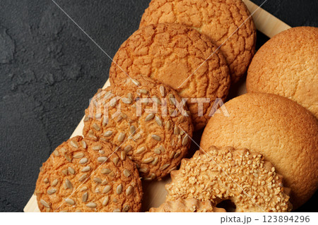 Freshly baked cookies arranged on a wooden tray in a cozy kitchen setting 123894296