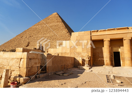 Exploring ancient pyramids and temples in Giza during the golden hour light Exploring ancient pyramids and temples in Giza during the golden hour light 123894443