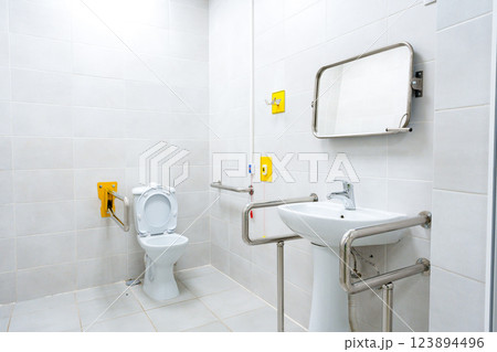 Clean accessibility restroom designed for comfort and convenience in a modern facility Clean accessibility restroom designed for comfort and convenience in a modern facility 123894496