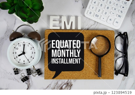 EMI - Equated Monthly Installment acronym with calculator, alarm clock and magnifying glass, Business and Financial concept background 123894519