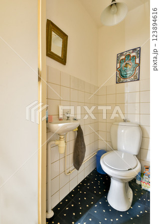 Features a modern bathroom with stylish fixtures, a mirror, and decorative tiles, creating a welcoming atmosphere for relaxation. Features a modern bathroom with stylish fixtures, a mirror, and decorative tiles, creating a welcoming atmosphere for relaxation. 123894616
