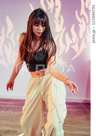 Dance performance in stylish attire showcasing elegance and movement in a vibrant studio setting 123894792