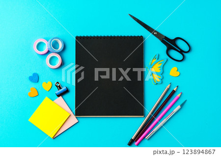 Creative workspace with colorful stationery arranged on a bright blue background for art projects Creative workspace with colorful stationery arranged on a bright blue background for art projects 123894867