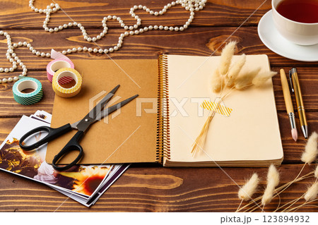 Creative workspace with scrapbook materials and decorative elements during the day 123894932