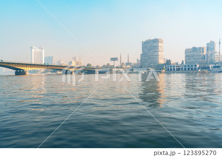 City skyline reflecting on water near a bridge in Cairo during early morning light City skyline reflecting on water near a bridge in Cairo during early morning light 123895270