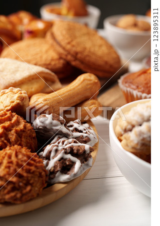 Delicious assortment of freshly baked cookies and pastries on a rustic table setting Delicious assortment of freshly baked cookies and pastries on a rustic table setting 123895311
