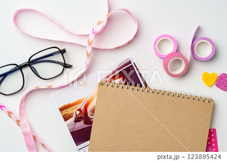 Creative workspace with stationery, photos, and decorative supplies for artistic projects and planning Creative workspace with stationery, photos, and decorative supplies for artistic projects and planning 123895424