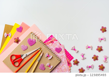 Crafting materials arranged for creative projects with colorful papers and decorative items 123895493