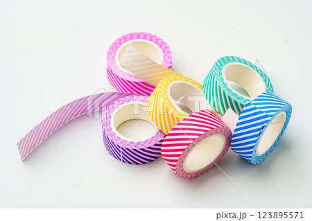 Colorful striped tape rolls for arts and crafts projects on a light background Colorful striped tape rolls for arts and crafts projects on a light background 123895571