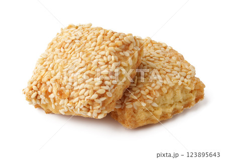 Crunchy sesame cookies stacked on a white background showcasing a delightful treat perfect for snacking or dessert Crunchy sesame cookies stacked on a white background showcasing a delightful treat perfect for snacking or dessert 123895643