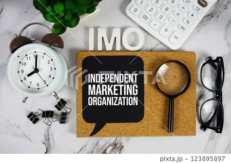 IMO - Independent Marketing Organization acronym with calculator, alarm clock and magnifying glass, Business and Financial concept background IMO - Independent Marketing Organization acronym with calculator, alarm clock and magnifying glass, Business and Financial concept background 123895897