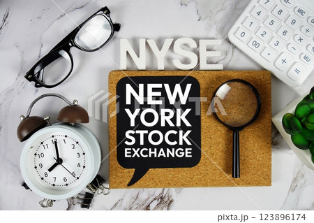 NYSE - New York Stock Exchange acronym with calculator, alarm clock and magnifying glass, Business concept background 123896174