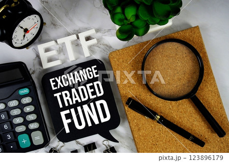 ETF - Exchange Traded Fund acronym with calculator, alarm clock and magnifying glass, Business and Financial concept background 123896179