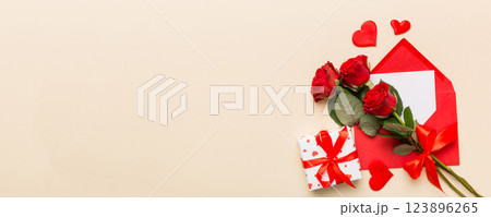 Valentine day composition with Envelope, rose flower and Red heart on table. Top view, flat lay. Holiday concept Valentine day composition with Envelope, rose flower and Red heart on table. Top view, flat lay. Holiday concept 123896265