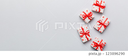 Valentine day composition: red gift box with bow and heart. Christmas present. View from above. Space for text. Holday greeting card 123896290