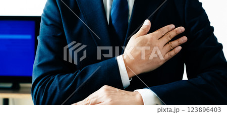 胸に手を当てるビジネスマン 胸に手を当てるビジネスマン 123896403