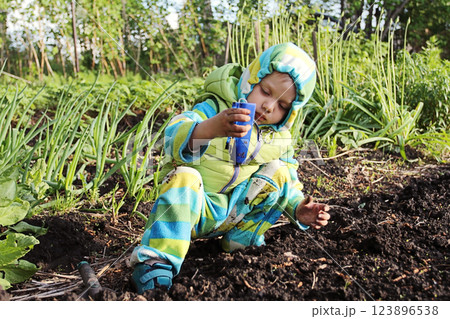 Funny Little Boy Playing In The Garden. 123896538
