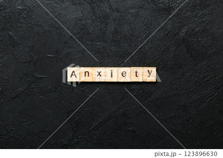 ANXIETY word written on wood block. ANXIETY text on table, concept 123896630