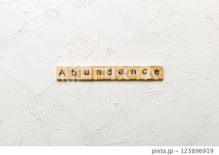 abundance word written on wood block. abundance text on table, concept abundance word written on wood block. abundance text on table, concept 123896919