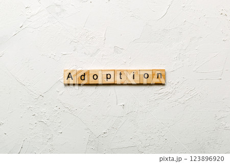 adoption word written on wood block. adoption text on table, concept 123896920