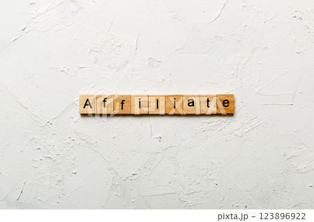 AFFILIATE word written on wood block. AFFILIATE text on cement table for your desing, concept AFFILIATE word written on wood block. AFFILIATE text on cement table for your desing, concept 123896922