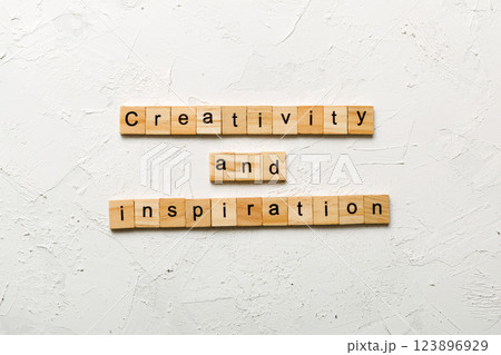 creativity and inspiration word written on wood block. creativity and inspiration text on cement table for your desing, concept 123896929