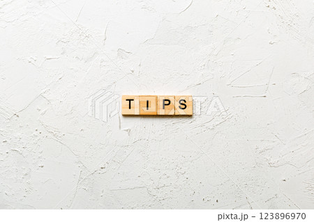 tips word written on wood block. tips text on table, concept tips word written on wood block. tips text on table, concept 123896970