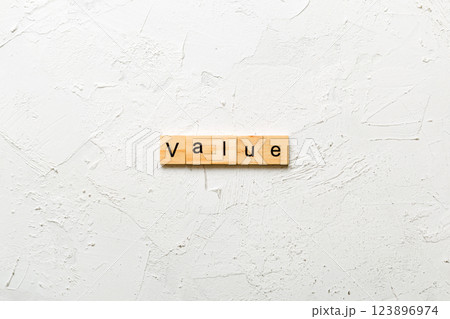 value word written on wood block. value text on table, concept 123896974