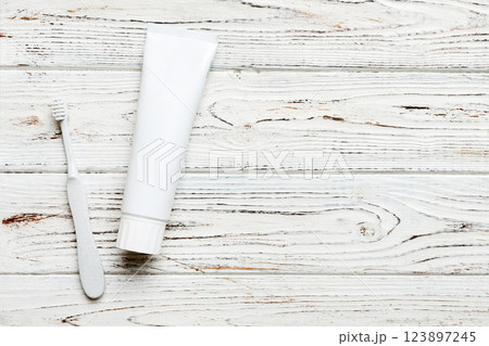 toothpaste and toothbrush top view with copy space on colored background. Flat lay. Dental hygiene. Oral care products on light background. Body care concept 123897245