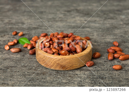 Fresh healthy peanuts in bowl on colored table background. Top view Healthy eating bertholletia concept. Super foods Fresh healthy peanuts in bowl on colored table background. Top view Healthy eating bertholletia concept. Super foods 123897266