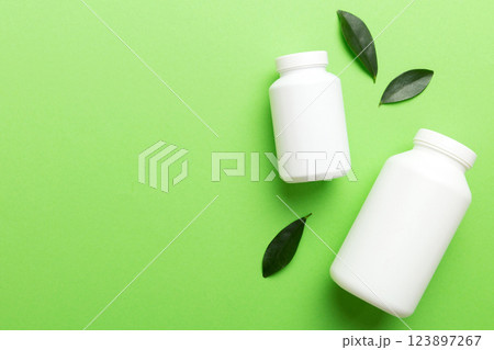 supplement pills with medicine bottle health care and medical top view. Vitamin tablets. Top view mockup bottle for pills and vitamins with green leaves, natural organic bio supplement, copy space supplement pills with medicine bottle health care and medical top view. Vitamin tablets. Top view mockup bottle for pills and vitamins with green leaves, natural organic bio supplement, copy space 123897267