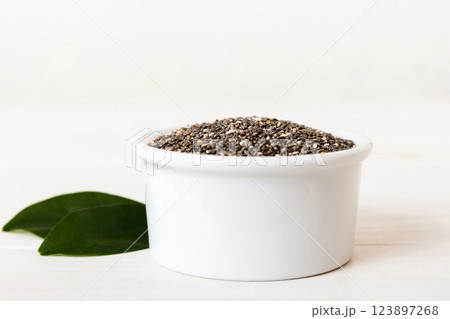 Chia seeds in bowl on colored background. Healthy Salvia hispanica in small bowl. Healthy superfood 123897268