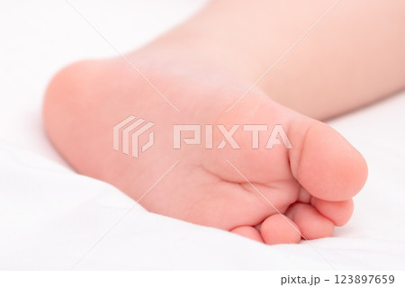 Legs close-up of newborn baby on light background Legs close-up of newborn baby on light background 123897659