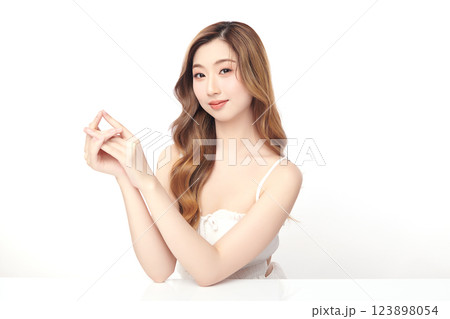 A beautiful young Asian woman with clean, fresh skin against a white background. She represents beauty, skincare, and spa treatments. A beautiful young Asian woman with clean, fresh skin against a white background. She represents beauty, skincare, and spa treatments. 123898054