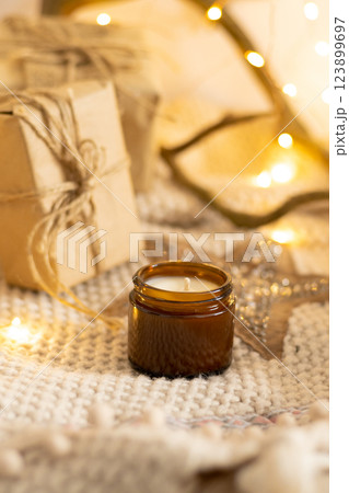 Soy aroma candle in beige background. Candle in a glass jar. 123899697