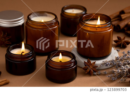 A set of different aroma candles in glass jars on a white background. Scented handmade candle. Soy candles are burning in a jar.Wax and paraffin in a jar 123899703