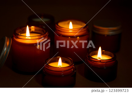 A set of different aroma candles in glass jars on a white background. Scented handmade candle. Soy candles are burning in a jar.Wax and paraffin in a jar 123899723