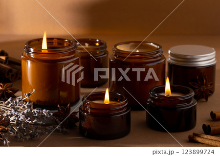 A set of different aroma candles in glass jars on a white background. Scented handmade candle. Soy candles are burning in a jar.Wax and paraffin in a jar 123899724