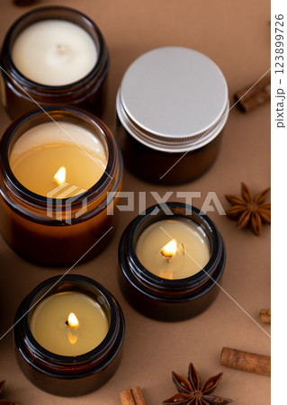 A set of different aroma candles in glass jars on a white background. Scented handmade candle. Soy candles are burning in a jar.Wax and paraffin in a jar 123899726