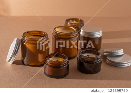 A set of different aroma candles in glass jars on a white background. Scented handmade candle. Soy candles are burning in a jar.Wax and paraffin in a jar 123899729