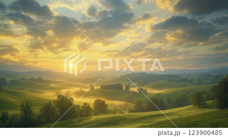 Golden sunrise over rolling hills and mist in a scenic landscape view 123900485