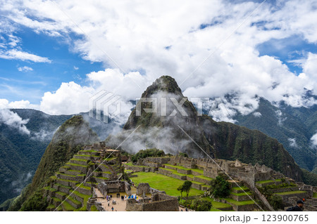 Panoramic view of Machu Picchu ruins surrounded by misty mountains, Peru 123900765