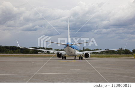 Passenger plane lands. Blue airplane on the platform of Airport. Runway. Landing aircraft. 123900815