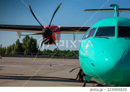Airplane medium-range turboprop passenger aircraft. Plane at the Airport. Cockpit close up. Runway. Propeller. Turbine engine. 123900820