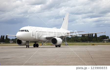 Passenger white plane lands. Airport. Runway. Landing aircraft. Passenger white plane lands. Airport. Runway. Landing aircraft. 123900833