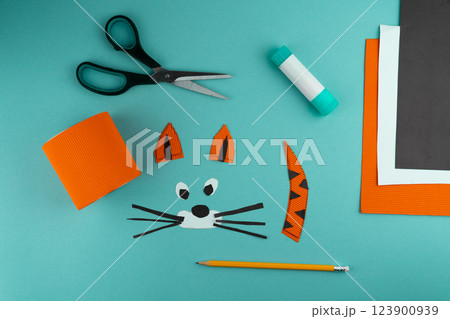 Step 5. Step-by-step instructions on how to make a stand for stationery from a tin can. Tiger made of paper and cardboard, scissors and glue. A fun DIY craft for children. Do it yourself paper tiger Step 5. Step-by-step instructions on how to make a stand for stationery from a tin can. Tiger made of paper and cardboard, scissors and glue. A fun DIY craft for children. Do it yourself paper tiger 123900939