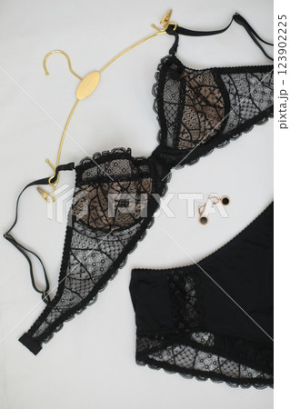 Woman's silk erotic lingerie on the white bed sheets. Valentine's day concept. Lace sexy female underwear. Beauty, fashion blogger concept. Female bra, panties, erotic clothes. Lingerie advertising Woman's silk erotic lingerie on the white bed sheets. Valentine's day concept. Lace sexy female underwear. Beauty, fashion blogger concept. Female bra, panties, erotic clothes. Lingerie advertising 123902225