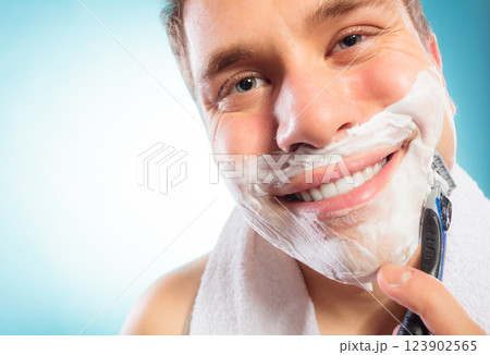 Man shaving using razor with cream foam. Man shaving using razor with cream foam. 123902565