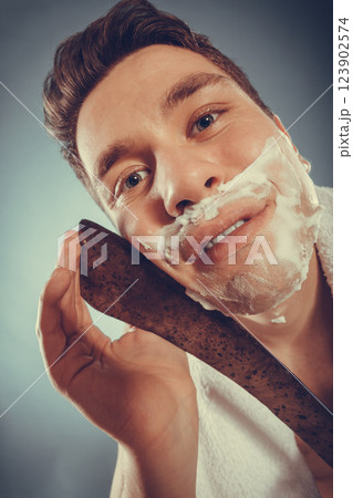 Young man shaving having fun with machete. 123902574
